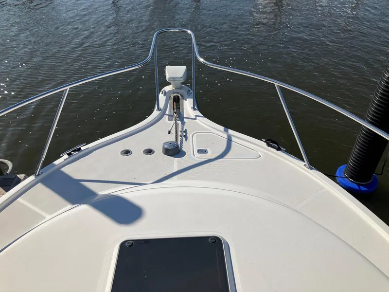 Slide: The Image of Bow of 2000 Pursuit 3400 Express boat on calm water. - 14