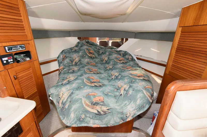Slide: The Image of Interior cabin of 2000 Pursuit 3400 Express with fish-patterned bedspread. - 16
