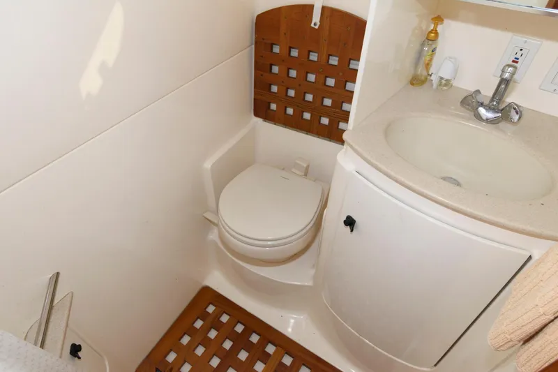 Slide: The Image of Compact bathroom in 2000 Pursuit 3400 Express boat with toilet and sink. - 17