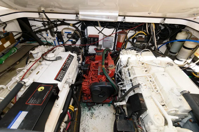 Slide: The Image of Engine room of a 2000 Pursuit 3400 Express boat, showcasing dual engines and wiring. - 18