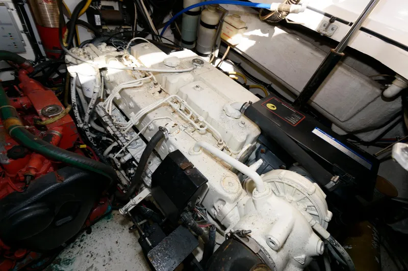 Slide: The Image of Engine room of a 2000 Pursuit 3400 Express boat, showcasing mechanical components. - 20