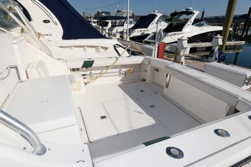 Slide: The Image of 2000 Pursuit 3400 Express boat with spacious deck, docked at marina. - 3