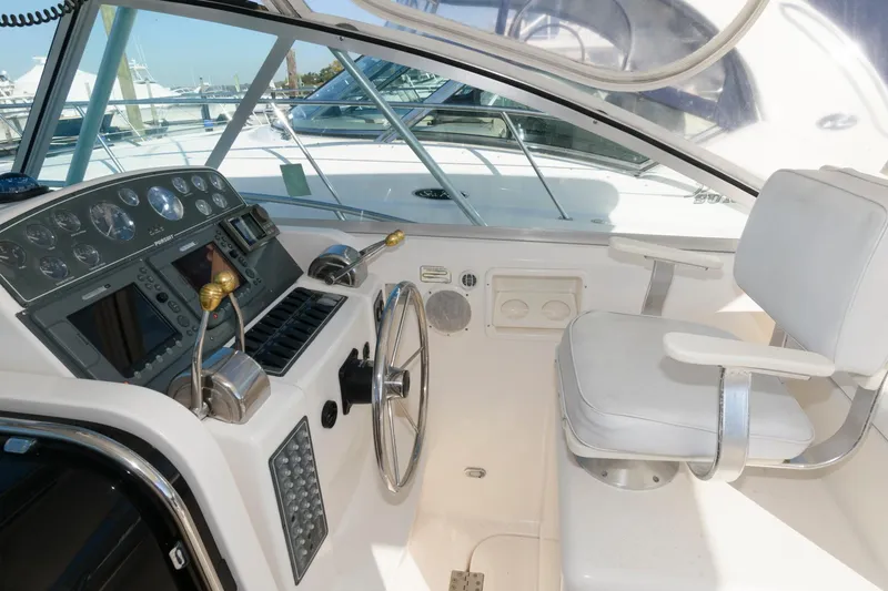 Slide: The Image of Helm of 2000 Pursuit 3400 Express boat with steering wheel and control panel. - 5