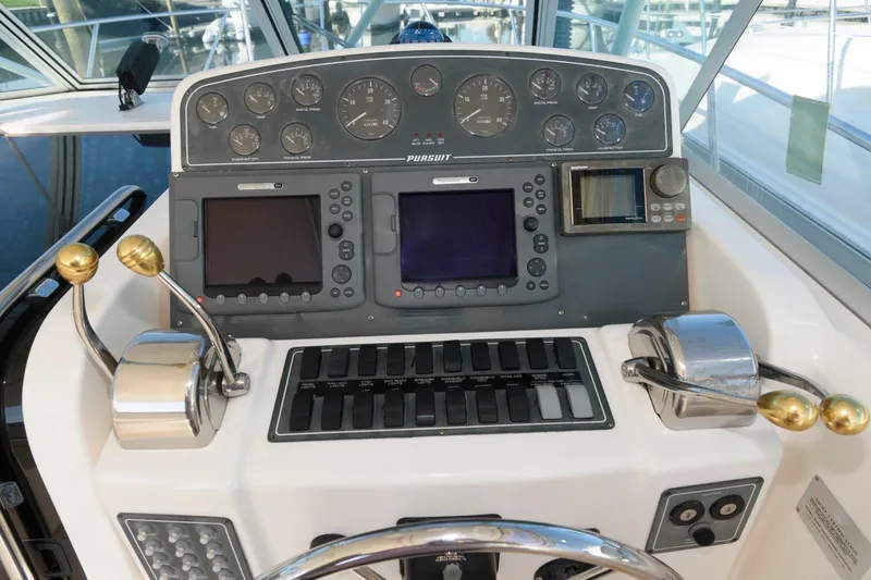 Slide: The Image of Control panel of a 2000 Pursuit 3400 Express boat with navigation instruments. - 8