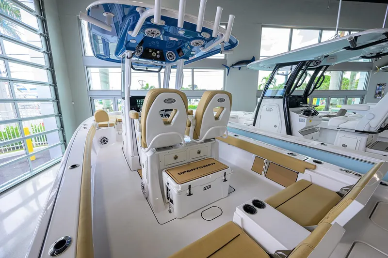 Slide: The Image of 2025 Sportsman Masters 267 Bay Boat interior with beige seating and modern helm station. - 11