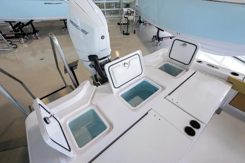 Slide: The Image of 2025 Sportsman Masters 267 Bay Boat with open storage compartments and Mercury engine. - 15