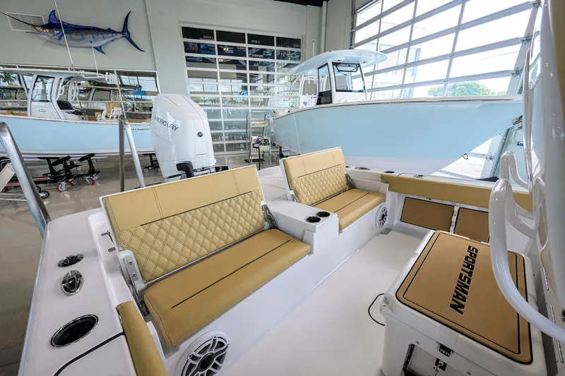 Slide: The Image of 2025 Sportsman Masters 267 Bay Boat interior with tan seating and modern design. - 17
