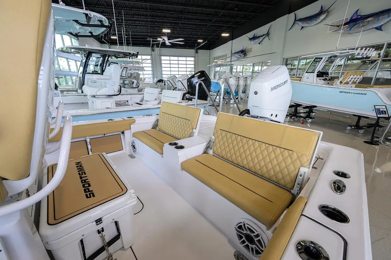 Slide: The Image of 2025 Sportsman Masters 267 Bay Boat interior with tan seating in showroom. - 18