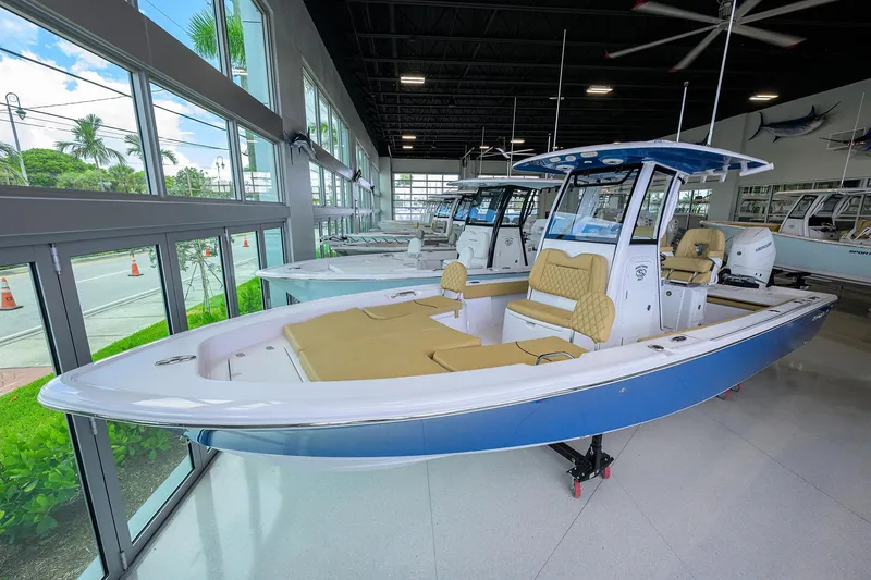 Slide: The Image of 2025 Sportsman Masters 267 Bay Boat in showroom, featuring sleek design and modern amenities. - 2