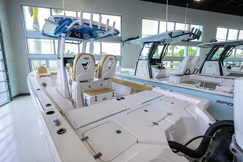 Slide: The Image of 2025 Sportsman Masters 267 Bay Boat in showroom, featuring modern design and spacious seating. - 20