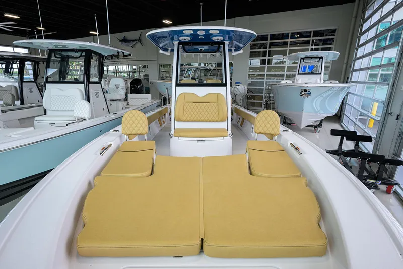 Slide: The Image of 2025 Sportsman Masters 267 Bay Boat interior with tan seating in showroom. - 28