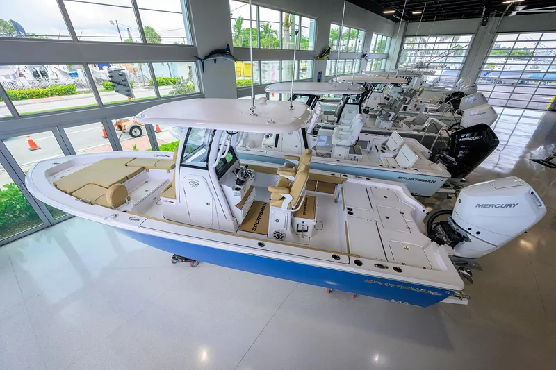 Slide: The Image of 2025 Sportsman Masters 267 Bay Boat in showroom, featuring sleek design and modern amenities. - 3