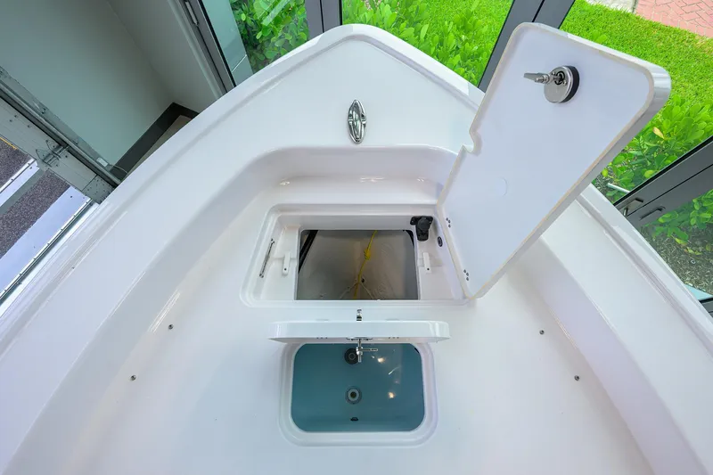 Slide: The Image of 2025 Sportsman Masters 267 Bay Boat interior storage compartments, open hatches, and sleek design. - 32