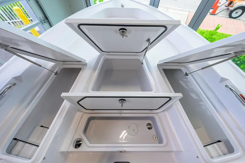 Slide: The Image of 2025 Sportsman Masters 267 Bay Boat storage compartments open, showcasing spacious interior design. - 33