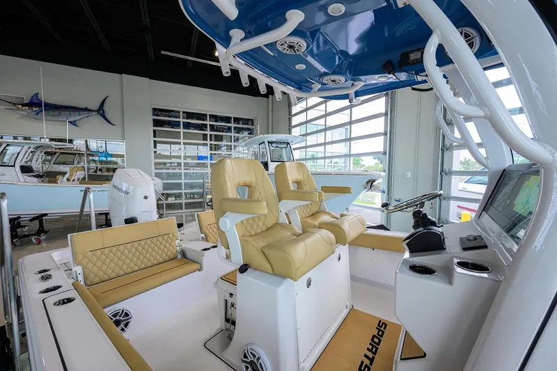 Slide: The Image of Interior of 2025 Sportsman Masters 267 Bay Boat with tan seating and modern controls. - 6