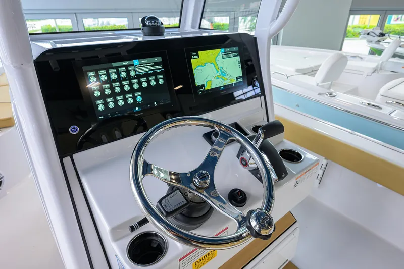 Slide: The Image of 2025 Sportsman Masters 267 Bay Boat dashboard with advanced navigation and control systems. - 8