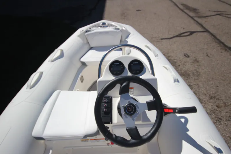 Slide: The Image of 2025 Zodiac Yachtline 360 DL PVC boat interior with steering wheel and controls. - 12