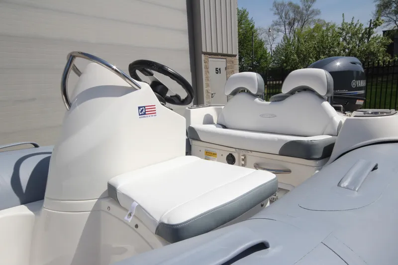 Slide: The Image of 2025 Zodiac Yachtline 360 DL PVC boat interior with steering wheel and seating. - 4