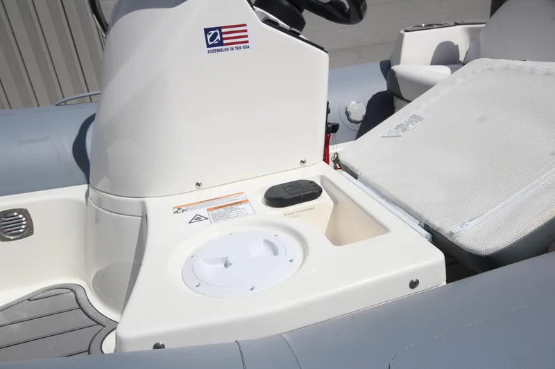 Slide: The Image of 2025 Zodiac Yachtline 360 DL PVC boat interior with control panel and seating area. - 9