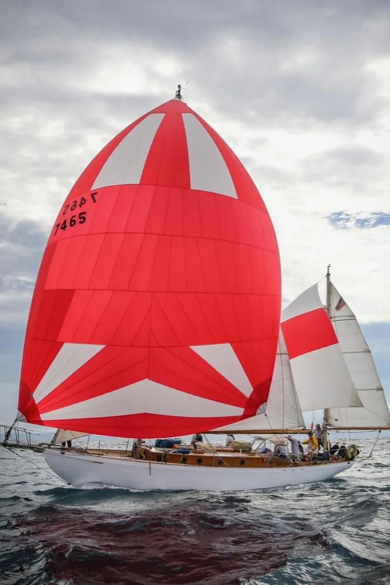 The Image of Historic 1932 Fellows & Stewart Yawl sailing with vibrant red and white sails on open water. - 0