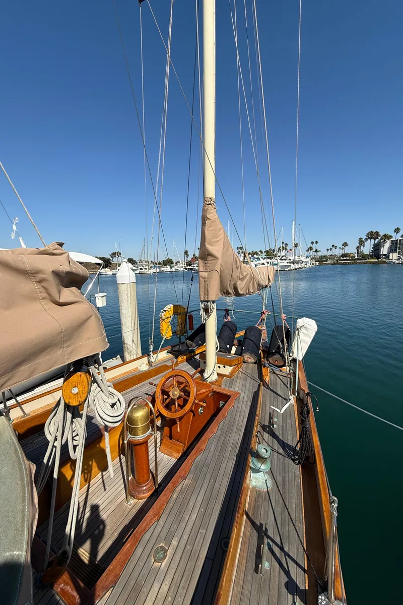 Slide: The Image of Historic 1932 Fellows & Stewart Yawl docked, showcasing wooden deck and rigging under clear blue sky. - 11