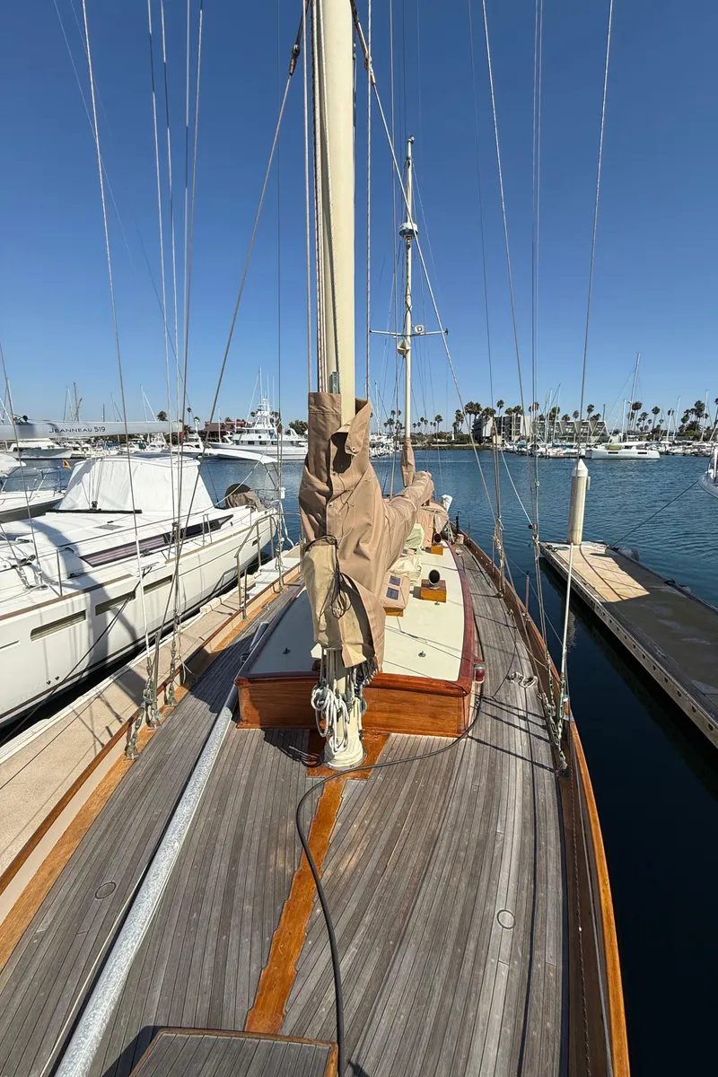 Slide: The Image of Historic 1932 Fellows & Stewart Yawl docked at marina under clear blue sky. - 12