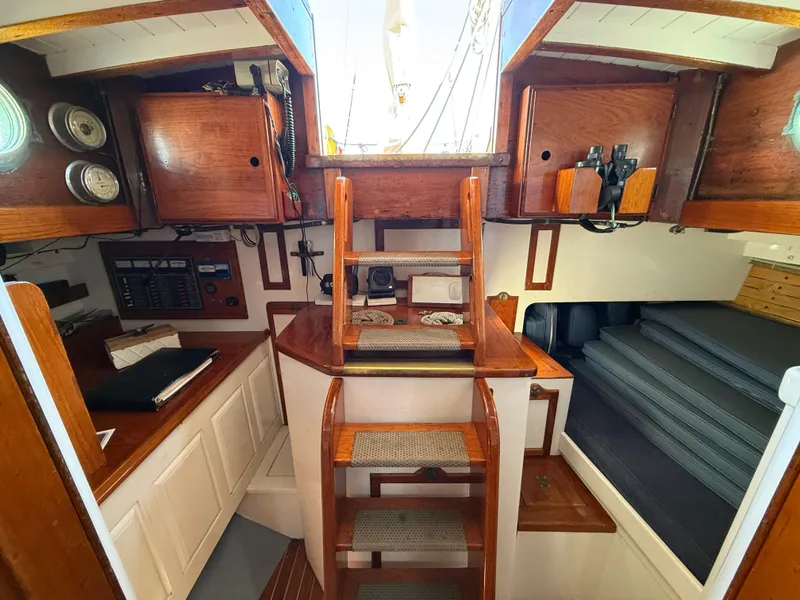 Slide: The Image of Interior of 1932 Historic Fellows & Stewart Yawl, featuring wooden cabinetry and nautical instruments. - 14