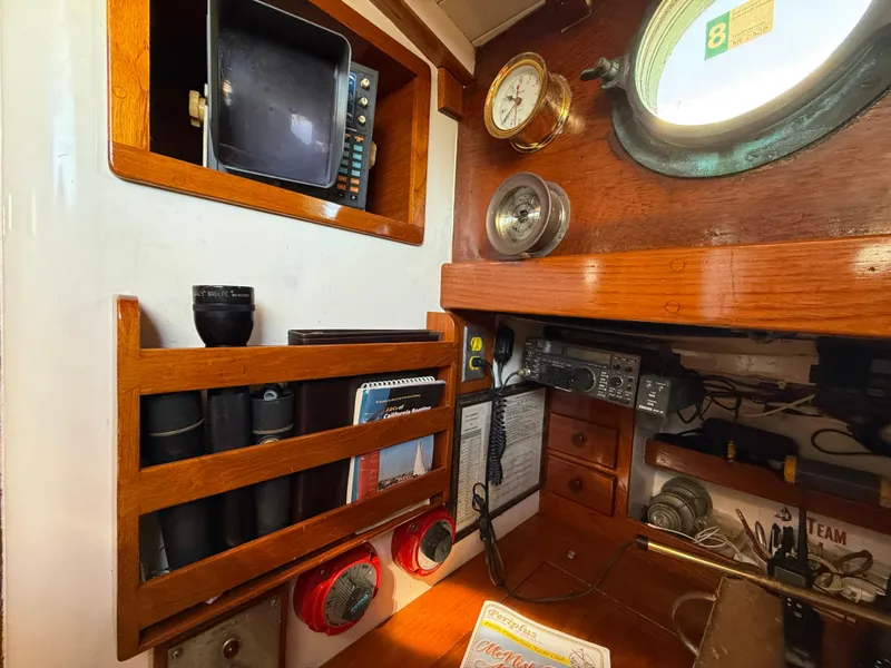 Slide: The Image of Interior of 1932 Historic Fellows & Stewart Yawl with vintage navigation equipment and wooden accents. - 17