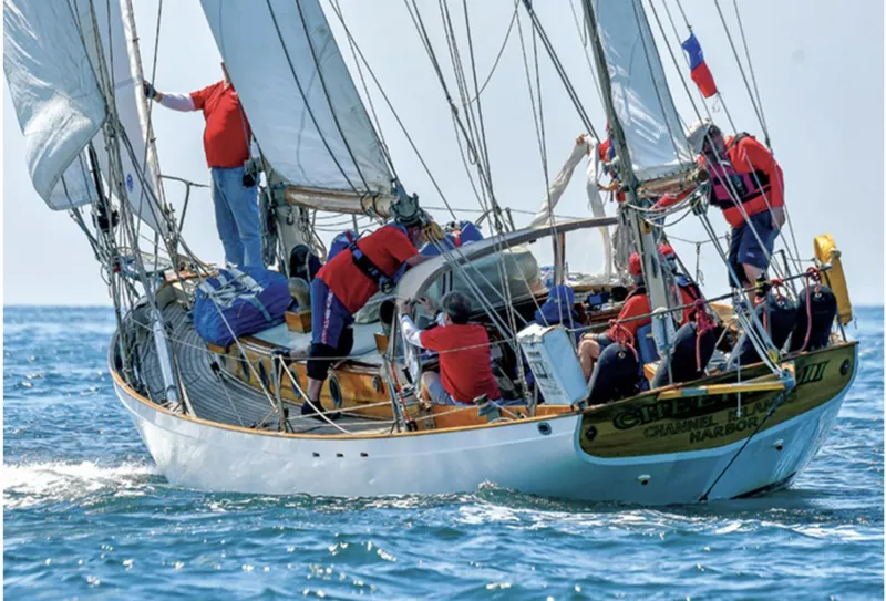 Slide: The Image of Historic 1932 Fellows & Stewart Yawl sailing with crew on open sea. - 2