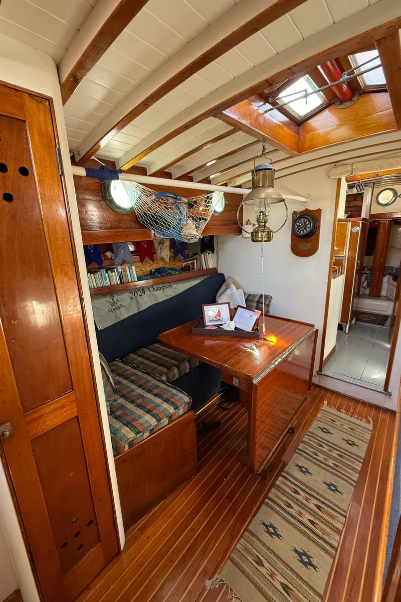 Slide: The Image of Interior of 1932 Historic Fellows & Stewart Yawl, featuring wooden furnishings and nautical decor. - 20