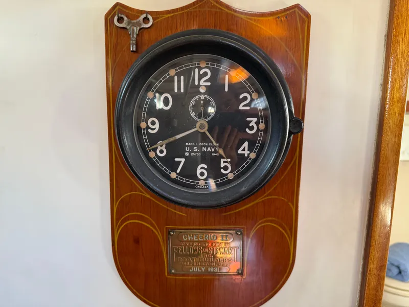 Slide: The Image of Wall-mounted U.S. Navy clock on 1932 Fellows & Stewart Yawl, with brass plaque and winding key. - 22