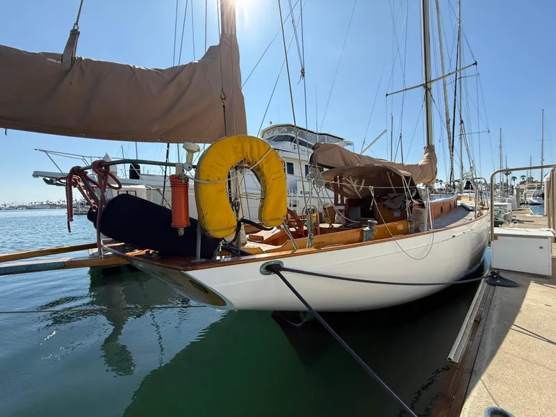 Slide: The Image of Historic 1932 Fellows & Stewart Yawl docked at marina, featuring classic design and wooden deck. - 5