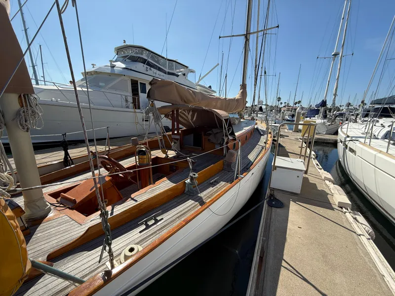 Slide: The Image of Historic 1932 Fellows & Stewart Yawl docked at marina, showcasing classic wooden design. - 6