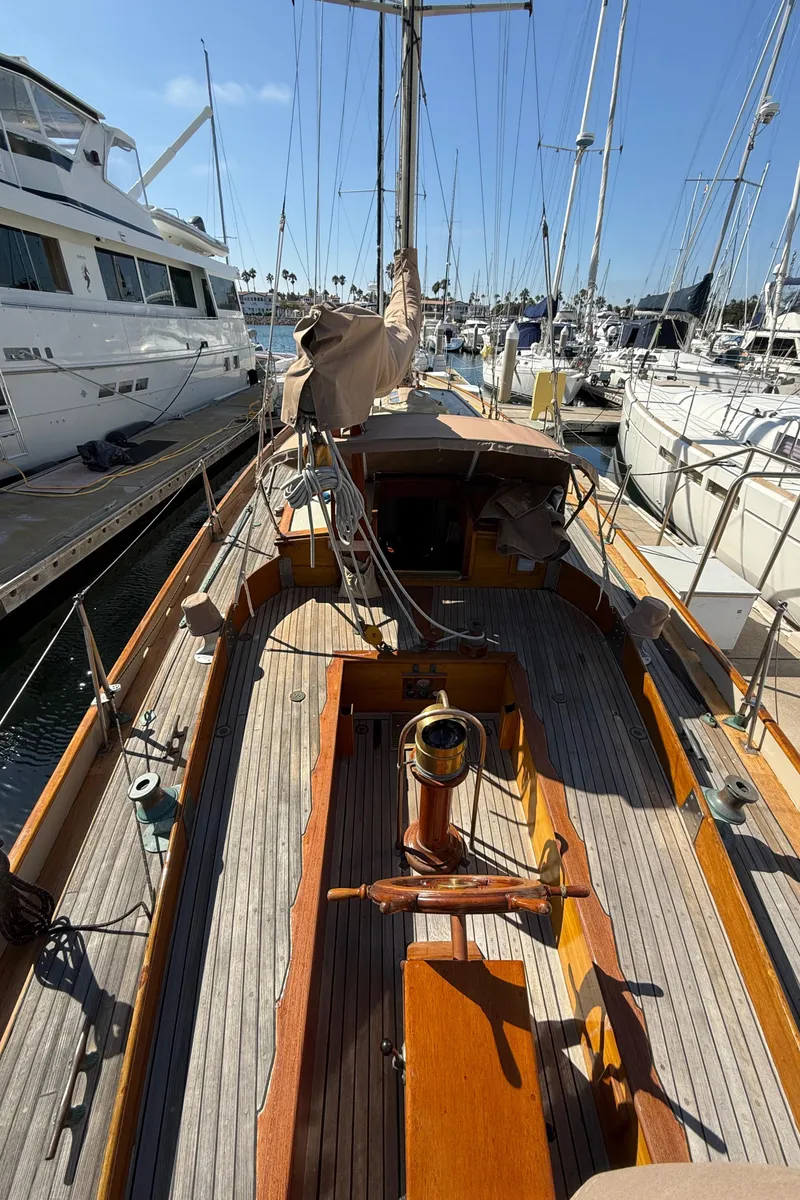 Slide: The Image of Historic 1932 Fellows & Stewart Yawl docked at marina, showcasing classic wooden deck design. - 7