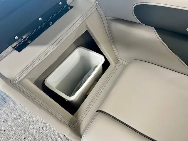 Slide: The Image of Barletta A22QC 2025 boat interior with built-in storage compartment and trash bin. - 10
