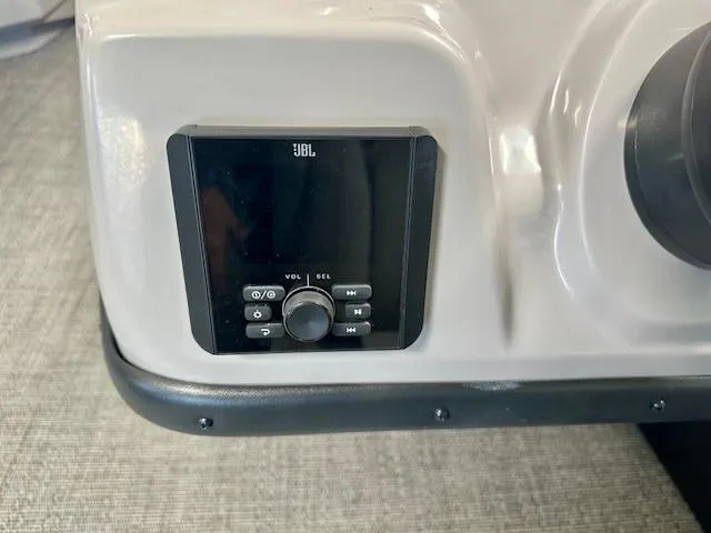 Slide: The Image of JBL audio control panel on 2025 Barletta A22QC boat dashboard. - 11