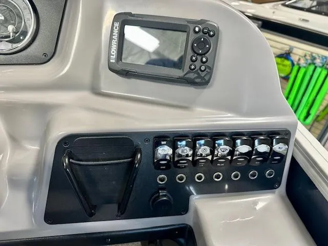 Slide: The Image of Control panel of 2025 Barletta A22QC boat with Lowrance device and switches. - 12