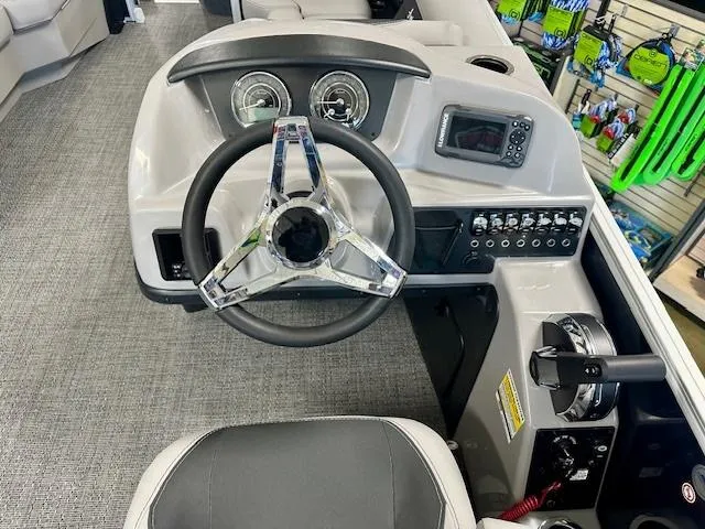 Slide: The Image of 2025 Barletta A22QC boat dashboard with steering wheel and control panel. - 7