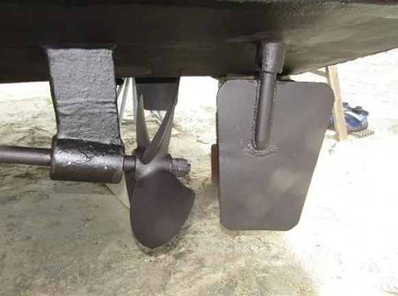 Slide: The Image of Close-up of a 1988 Custom Universal Ship Building Sport's propeller and rudder. - 13