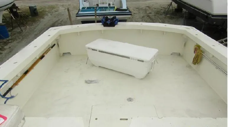 Slide: The Image of 1988 Custom Universal Ship Building Sport boat deck with storage box, clean and spacious layout. - 14