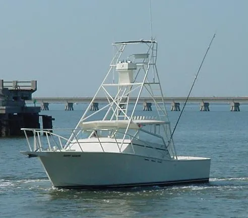 Slide: The Image of 1988 Custom Universal Ship Building Sport boat on water near a bridge. - 15