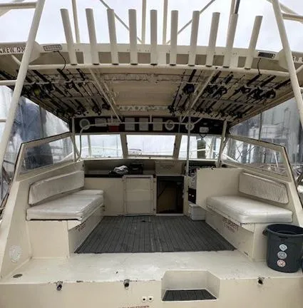 Slide: The Image of 1988 Custom Universal Ship Building Sport boat interior with fishing rod holders and seating. - 3