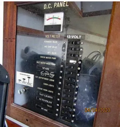 Slide: The Image of 1988 Custom Universal Ship Building Sport DC panel with volt meter and switches. - 6