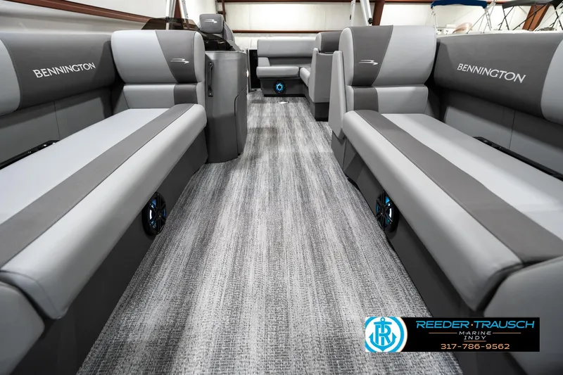 Slide: The Image of 2025 Bennington 118 SLS boat interior with gray seating and carpet flooring. - 13