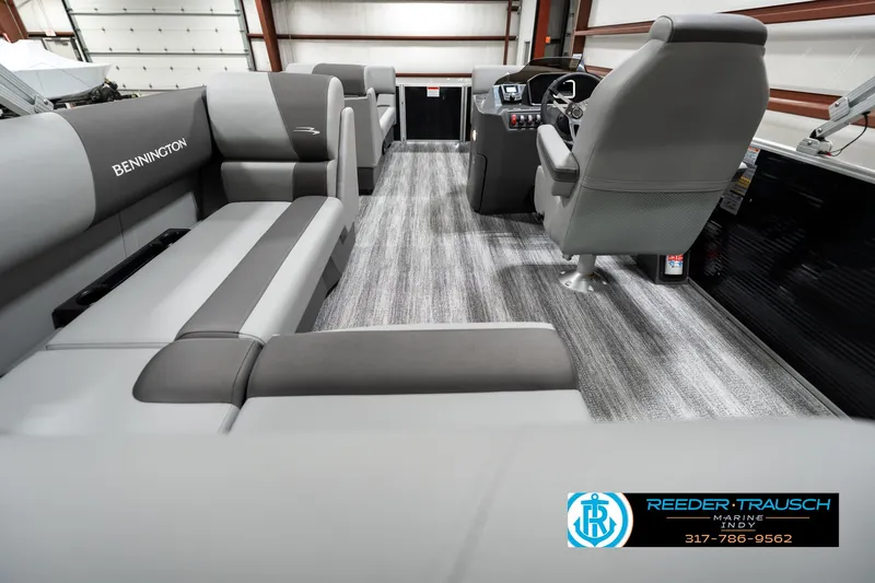 Slide: The Image of 2025 Bennington 118 SLS boat interior with gray seating and modern dashboard. - 16
