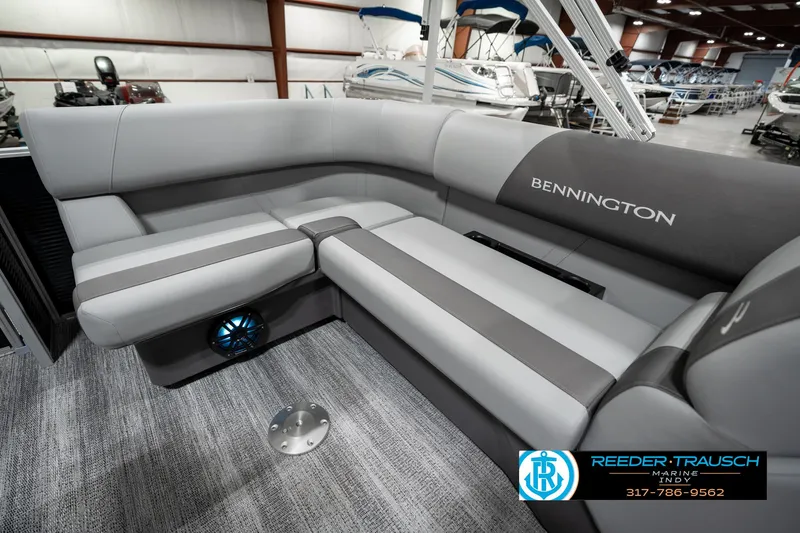 Slide: The Image of 2025 Bennington 118 SLS boat interior with gray seating in showroom. - 22