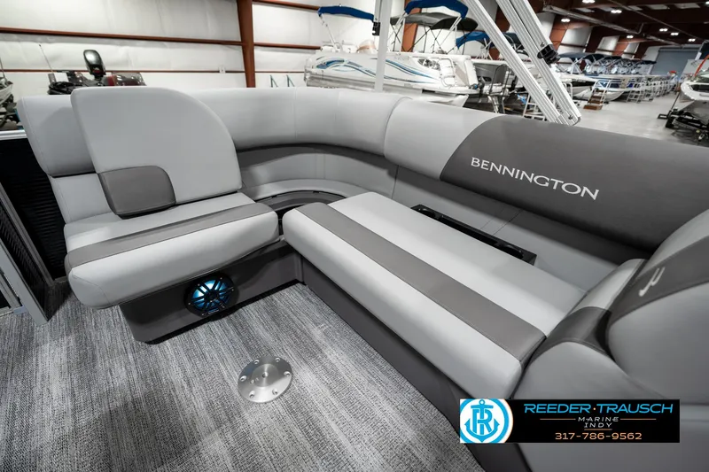 Slide: The Image of 2025 Bennington 118 SLS pontoon boat interior with gray seating in showroom. - 25