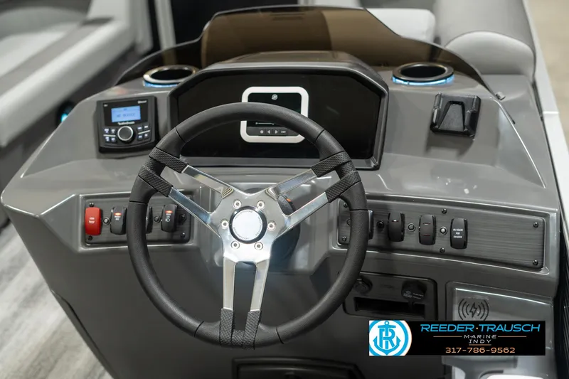 Slide: The Image of 2025 Bennington 118 SLS boat dashboard with steering wheel and control panel. - 27