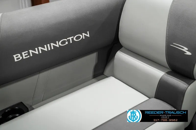 Slide: The Image of 2025 Bennington 118 SLS boat interior with gray seating and logo detailing. - 36