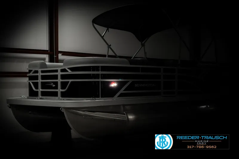Slide: The Image of 2025 Bennington 118 SLS pontoon boat in dimly lit showroom. - 4